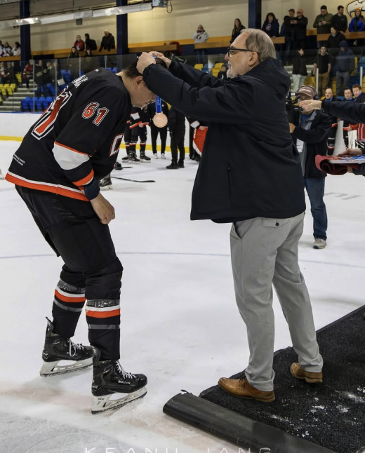 Shawn Mayzes playing hockey for Team Canada, wearing jersey number 61